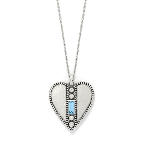 Brighton heart pendant necklace with hammered silver-plated finish, beaded edges, and blue crystal baguette on a white background