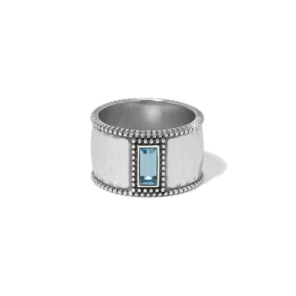 Brighton silver-plated wide band ring with hammered finish, beaded edges, and blue crystal baguette on a white background