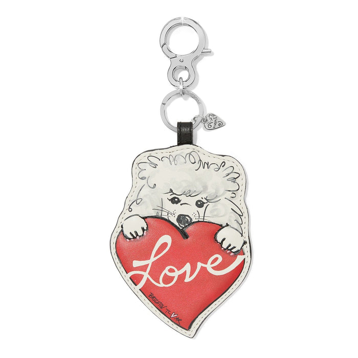 Brighton leather bag charm with illustrated white dog holding a red Love heart on a white background