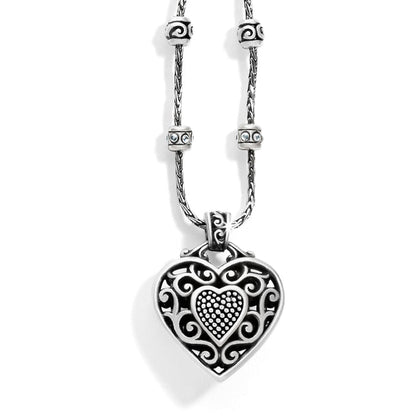 Brighton pendant necklace with silver-plated filigree heart, crystal-accented beaded stations, and rope chain on a white background