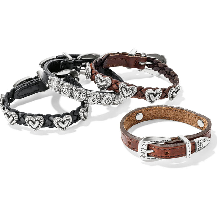 Brighton leather bracelets with silver-plated heart accents, buckle closures, and braided and smooth bands on a white background