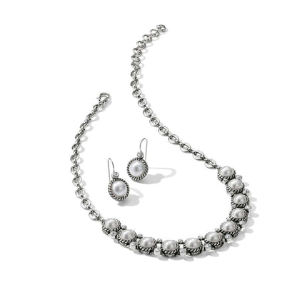 Brighton silver-plated necklace and drop earrings set with glass pearls and crystal accents on a white background