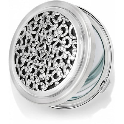Brighton compact mirror with silver-tone scrollwork filigree design on hinged round case on a white background