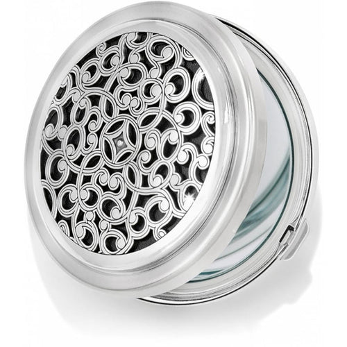 Brighton compact mirror with silver-tone scrollwork filigree design on hinged round case on a white background