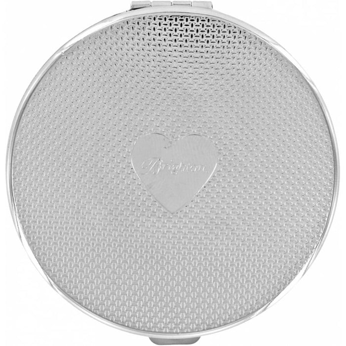 Brighton round silver-tone compact with woven texture pattern and engraved heart emblem at center on a white background
