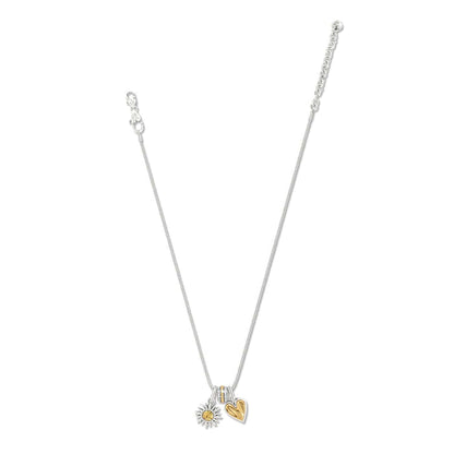 Brighton silver-plated charm necklace with crystal accent, silver sunflower charm, and gold heart charm on a white background