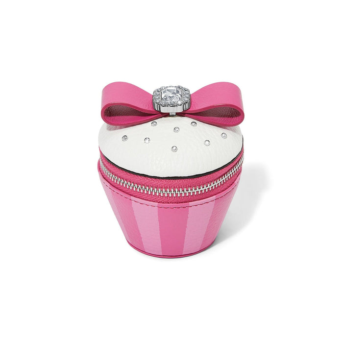 Brighton cupcake-shaped coin pouch with pink bow, crystal ring topper, white frosting, and zipper closure on a white background