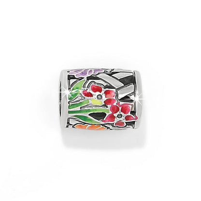 Brighton silver-plated barrel charm with enamel floral design in pink, purple, green, and orange on a white background