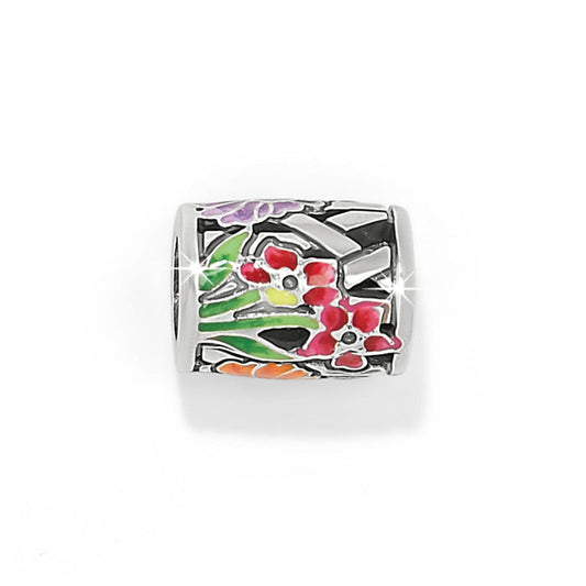 Brighton silver-plated barrel charm with enamel floral design in pink, purple, green, and orange on a white background