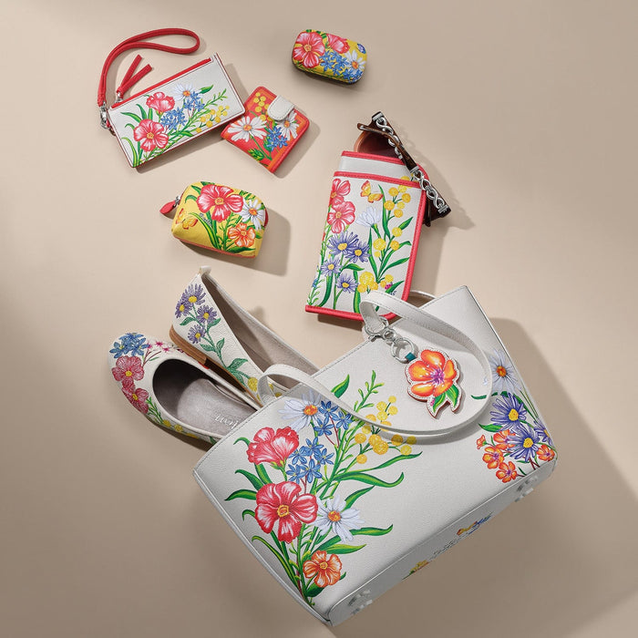 Brighton floral print handbag styled with matching wallets and ballet flats on a neutral background