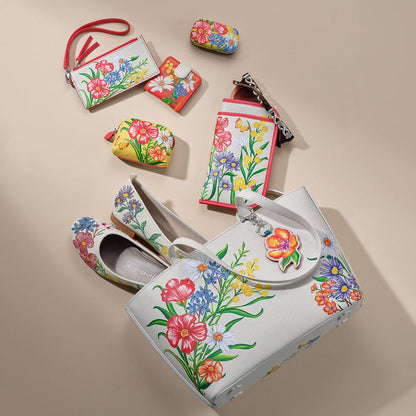 Brighton floral print handbag styled with matching wallets and ballet flats on a neutral background.