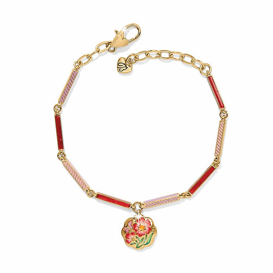 Brighton gold-plated bracelet with pink and red enamel bar links and floral enamel charm on a white background