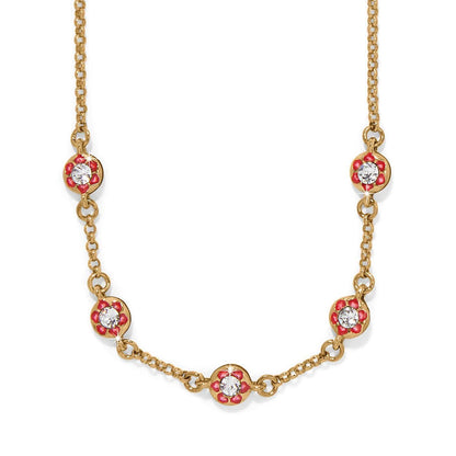 Brighton gold-plated necklace with red enamel flower stations and crystal centers on a white background