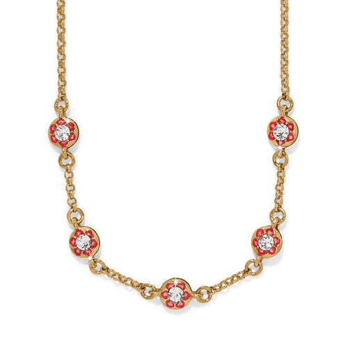 Brighton gold-plated necklace with red enamel flower stations and crystal centers on a white background