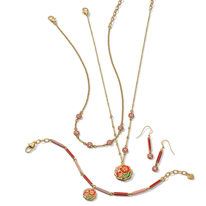 Brighton gold-plated jewelry set styled with floral enamel pendants, crystal stations, and red enamel drop earrings