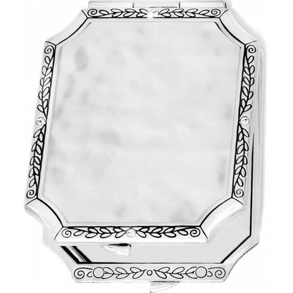 Brighton silver-tone compact mirror with engraved leaf border, crystal accents, and hammered center panel on a white background