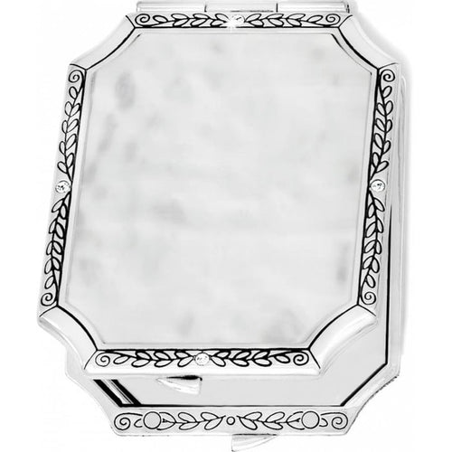 Brighton silver-tone compact mirror with engraved leaf border, crystal accents, and hammered center panel on a white background