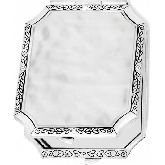 Brighton silver-tone compact mirror with engraved leaf border, crystal accents, and hammered center panel on a white background