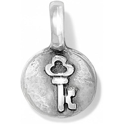 Brighton charm with silver-plated round medallion featuring embossed skeleton key design and top loop on a white background