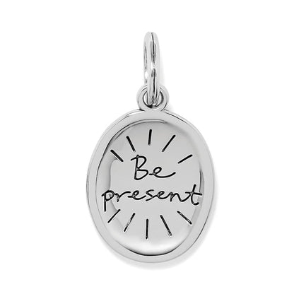 Brighton oval charm with engraved Be Present script and silver-plated finish with radiating lines on a white background