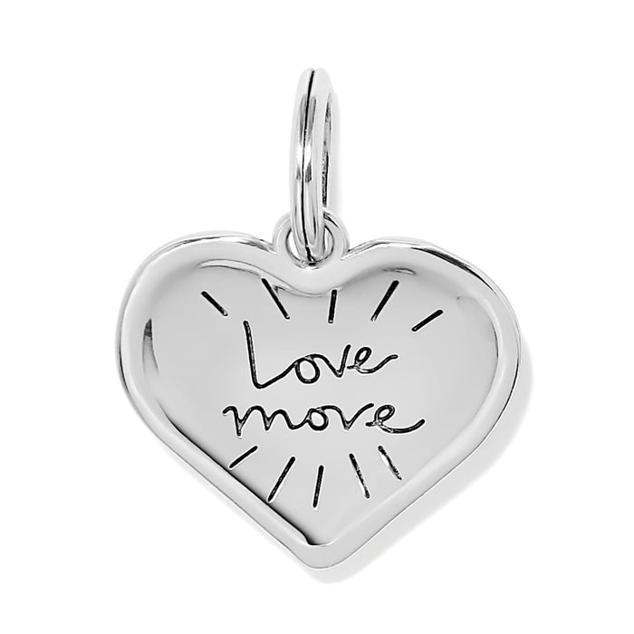 Brighton heart charm in silver-tone finish engraved with Love More script and radiating lines on a white background