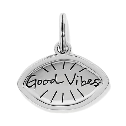 Brighton silver-plated charm with eye shape and engraved Good Vibes script and sun rays on a white background