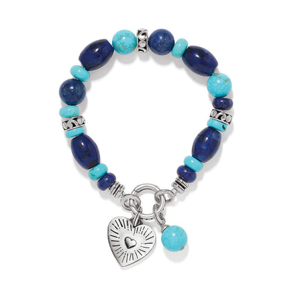 Brighton beaded bracelet with lapis lazuli and turquoise stones, silver-plated heart charm, and toggle clasp on a white background