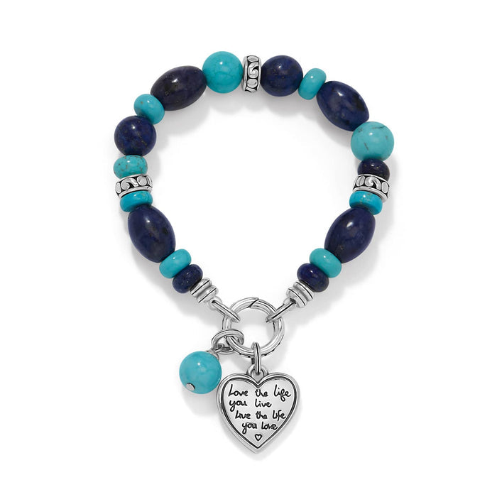 Brighton beaded bracelet with turquoise and lapis lazuli stones and silver-plated heart charm on a white background