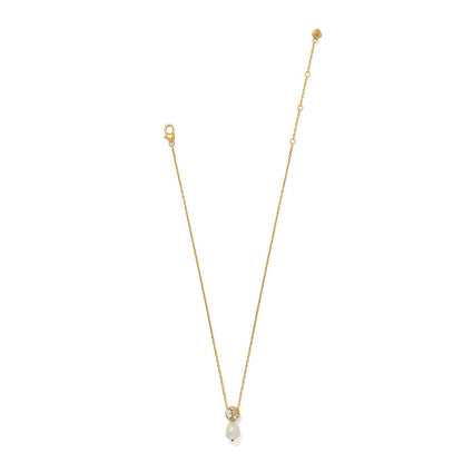 Brighton gold-plated pendant necklace with crystal-accented sphere and baroque pearl drop on a white background