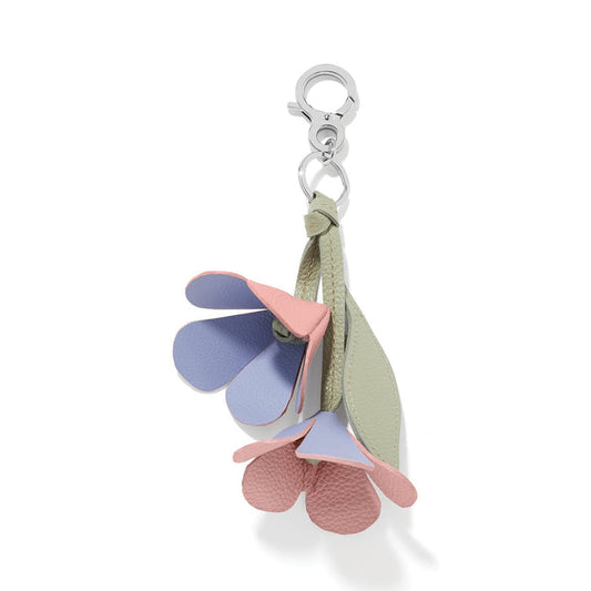 Brighton floral bag charm with pink and lavender leather petals, green leaf, and silver-tone clasp on a white background