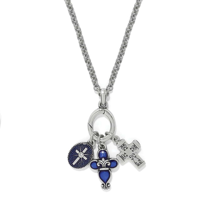 Brighton charm necklace with blue enamel medallion, fleur-de-lis charm, and silver-plated cross pendant on a white background