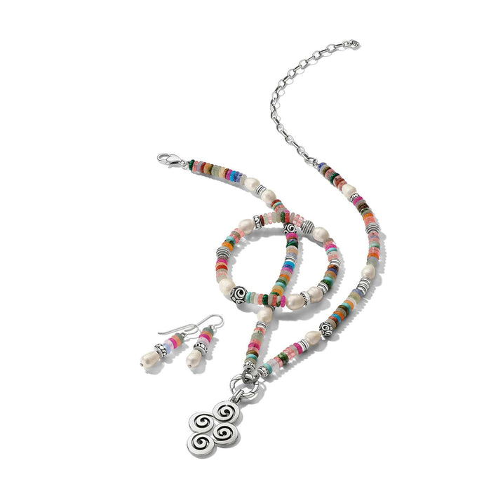 Brighton silver-plated jewelry set styled with multicolor beaded necklace, bracelet, and pearl drop earrings on white background