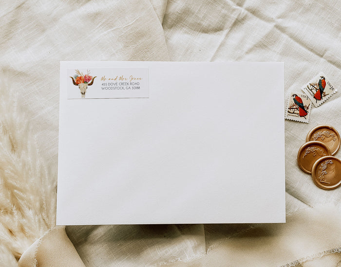 White envelope with address label on a textured beige surface